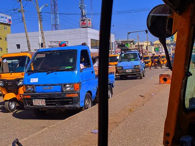 Commercial vehicles and passengers at a Nigerian transport hub